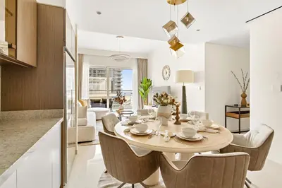 a dining room and living room with a table and chairs at Luxury 2BR at Grand Bleu in Dubai