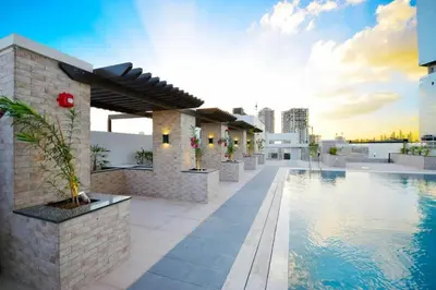 a swimming pool on the roof of a building at HAVN - New 1 Bedroom Apartment in Regent Court JVC in Dubai