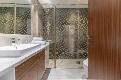 a bathroom with a sink and a shower at HAVN - New 1 Bedroom Apartment in Regent Court JVC in Dubai
