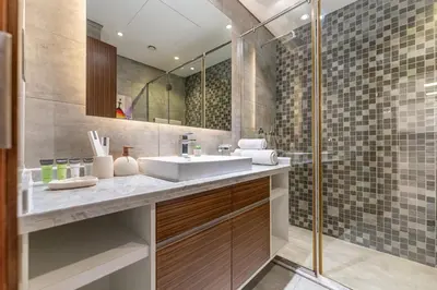 a bathroom with a sink and a shower at HAVN - New 1 Bedroom Apartment in Regent Court JVC in Dubai