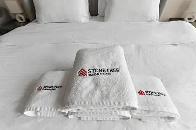 a bed with white towels on it with at Stonetree - Cozy 1 BR at MBL Near Metro in Dubai