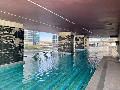a swimming pool in the middle of a building at Stonetree - Cozy 1 BR at MBL Near Metro in Dubai