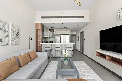 a living room with a couch and a table at Stonetree - Cozy 1 BR at MBL Near Metro in Dubai