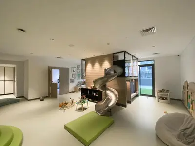 a living room with a slide in the middle at Sleek & Modern 1BR with Luxury Pool in JVC in Dubai