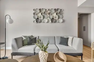a living room with a couch and a painting on the wall at GuestReady - Beautiful home in the JLT area in Dubai