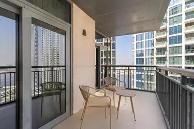 a balcony with two chairs and a table on it at Stonetree - Spacious 2BR at Dubai Creek Residences in Dubai