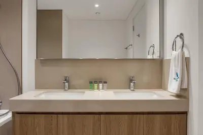 a bathroom with two sinks and a mirror at Bellavista - 2 Bedroom Downtown Views II T2 in Dubai