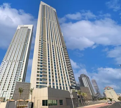 a tall building with two tall buildings in a city at Bellavista - 2 Bedroom Downtown Views II T2 in Dubai
