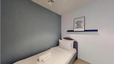 a small bedroom with a bed with white sheets at Paloma - Three Bed with Mesmerizing Marina View in Dubai