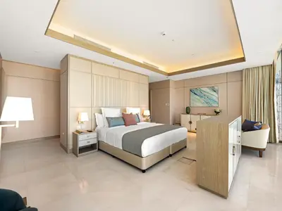 a large bedroom with a bed and a couch at FIVE luxe JBR - High Floor Studio - Pool & Beach Access - Ventura Stays in Dubai