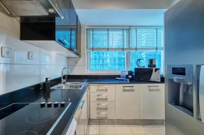 a kitchen with white cabinets and a sink at Dubai Marina, Beach & Marina View , 2 Bed Perfect for Groups in Dubai