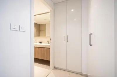 a bathroom with white cabinets and a sink at Fresh New 2 Bedroom! Amazing Burj Khalifa View! 5-star Pool & Gym Access! in Dubai