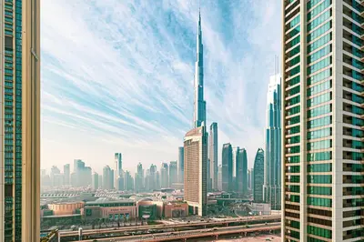 a view of a city with a tall skyscraper at Fresh New 2 Bedroom! Amazing Burj Khalifa View! 5-star Pool & Gym Access! in Dubai