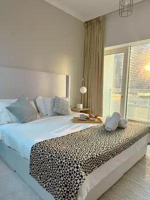 a bedroom with a large bed with a leopard print blanket at 5 minutes walk to Dubai mall and Burj Khalifa in Dubai