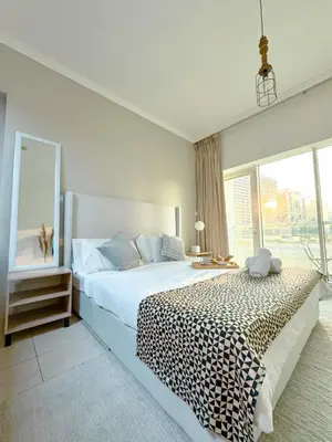 a bedroom with a large bed with a leopard print blanket at 5 minutes walk to Dubai mall and Burj Khalifa in Dubai