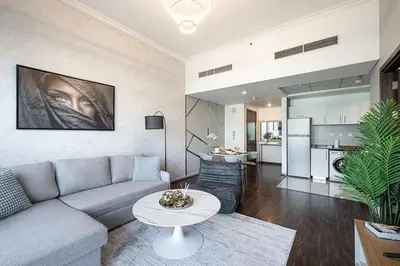a living room with a couch and a table at Panoramic Marina View - 1BR - Walk to the beach in Dubai
