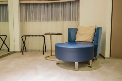 a blue chair and a table in a room at Lavish Studio at Creek Heights Residences - Boutique Concept by UDH in Dubai