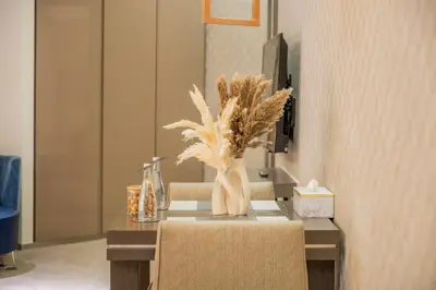 a table with a vase of plants on it at Lavish Studio at Creek Heights Residences - Boutique Concept by UDH in Dubai