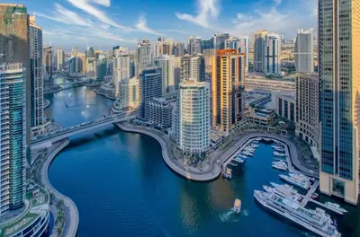 a view of a city with a river and buildings at Waterfront 1BR - Marina Views - Walk to Beach & Mall in Dubai