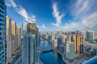 a view of a city with a river and buildings at Waterfront 1BR - Marina Views - Walk to Beach & Mall in Dubai