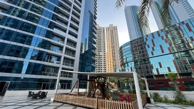 a playground in a city with tall buildings at Waterfront 1BR - Marina Views - Walk to Beach & Mall in Dubai