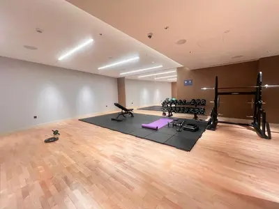 an empty room with a gym with exercise equipment at Daniels 1BR at Waves Grande In Sobha Hartland in Dubai