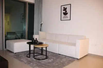 a living room with a white couch and a table at Downtown views prime location Dubai mall in Dubai