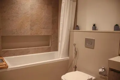 a bathroom with a tub and a toilet and a shower at Downtown views prime location Dubai mall in Dubai