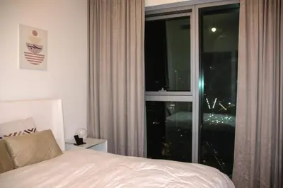 a bedroom with a bed and a large window at Downtown views prime location Dubai mall in Dubai