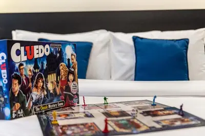 a table with a lego board game on a bed at Spacious 1-BR Opposite Mall with Huge Pool & Gym in Dubai