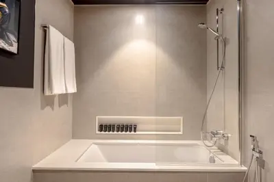 a bathroom with a bath tub and a shower at Brand New LUXE Downtown Dubai 46th Floor in Dubai