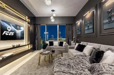 a living room with a couch and a tv at Brand New LUXE Downtown Dubai 46th Floor in Dubai