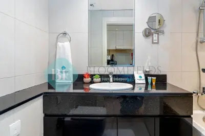a bathroom with a sink and a mirror at Bloomfields Stylish Stu in Damac Ghalia in Dubai