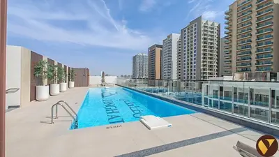 a swimming pool on the roof of a building at Vogue JVC Binghatti Galaxy near Circle Mall, Studio Apartment with Balcony and City View, Access to all Amenities in Dubai