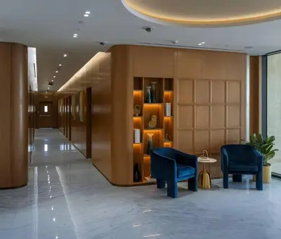 a lobby with two blue chairs in a building at Vogue JVC Binghatti Galaxy near Circle Mall, Studio Apartment with Balcony and City View, Access to all Amenities in Dubai