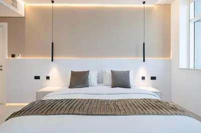 a bedroom with a large bed with two pillows at Downtown Views - For Big families & Groups - Up to 13 Guests - 6 min from Burj Khalifa in Dubai