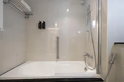 a bathroom with a shower and a bath tub at Downtown Views - For Big families & Groups - Up to 13 Guests - 6 min from Burj Khalifa in Dubai