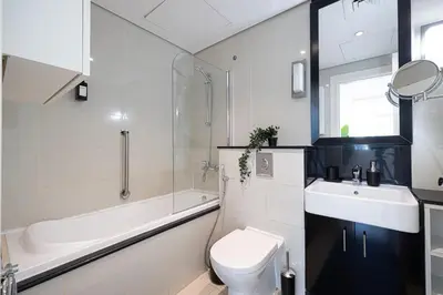 a bathroom with a toilet and a sink and a tub at Downtown Views - For Big families & Groups - Up to 13 Guests - 6 min from Burj Khalifa in Dubai