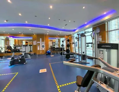 a fitness room with a gym with tread machines at Great & huge apartment high floor! in Dubai