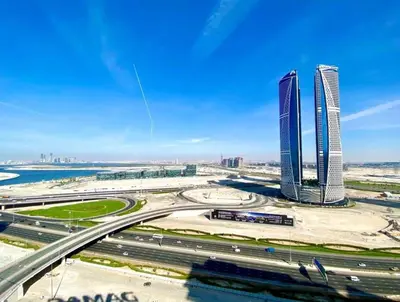 a city with two tall buildings and a highway at Great & huge apartment high floor! in Dubai