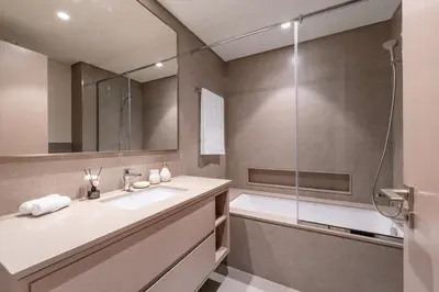 a bathroom with a sink and a shower at Hermes-Style 2BR, Full Burj Khalifa View - Infinity Pool - Full Fountain View in Dubai