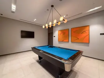 a pool table in a room with art on the wall at Hermes-Style 2BR, Full Burj Khalifa View - Infinity Pool - Full Fountain View in Dubai