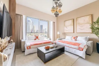two beds in a room with a large window at Hermes-Style 2BR, Full Burj Khalifa View - Infinity Pool - Full Fountain View in Dubai