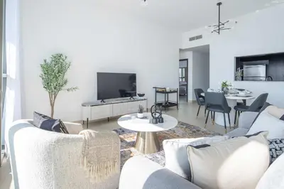 a living room with two couches and a table at Frank Porter - Downtown Views in Dubai