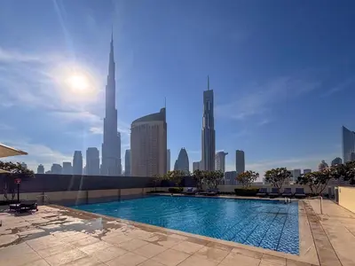 a swimming pool on a building with a city skyline at Frank Porter - Downtown Views in Dubai