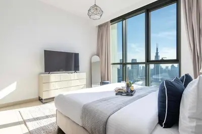 a hotel room with a bed and a large window at Frank Porter - Downtown Views in Dubai