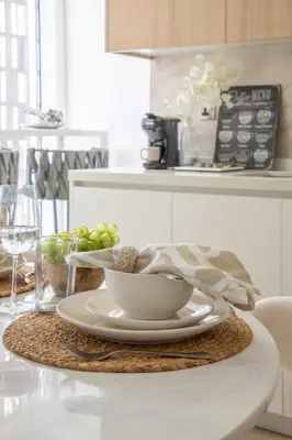 a table with a plate and a bowl of grapes at Frank Porter - Cayan Tower in Dubai