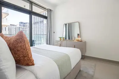 a bedroom with a bed and a large window at Frank Porter - Beach Vista Tower 2 in Dubai