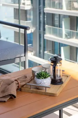 a tray with a coffee pot and a candle on a table at Frank Porter - Beach Vista Tower 2 in Dubai