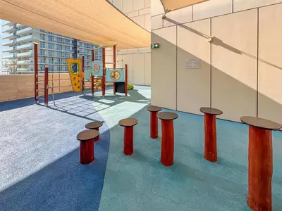 a group of stools in a room with a playground at Frank Porter - Beach Vista Tower 2 in Dubai